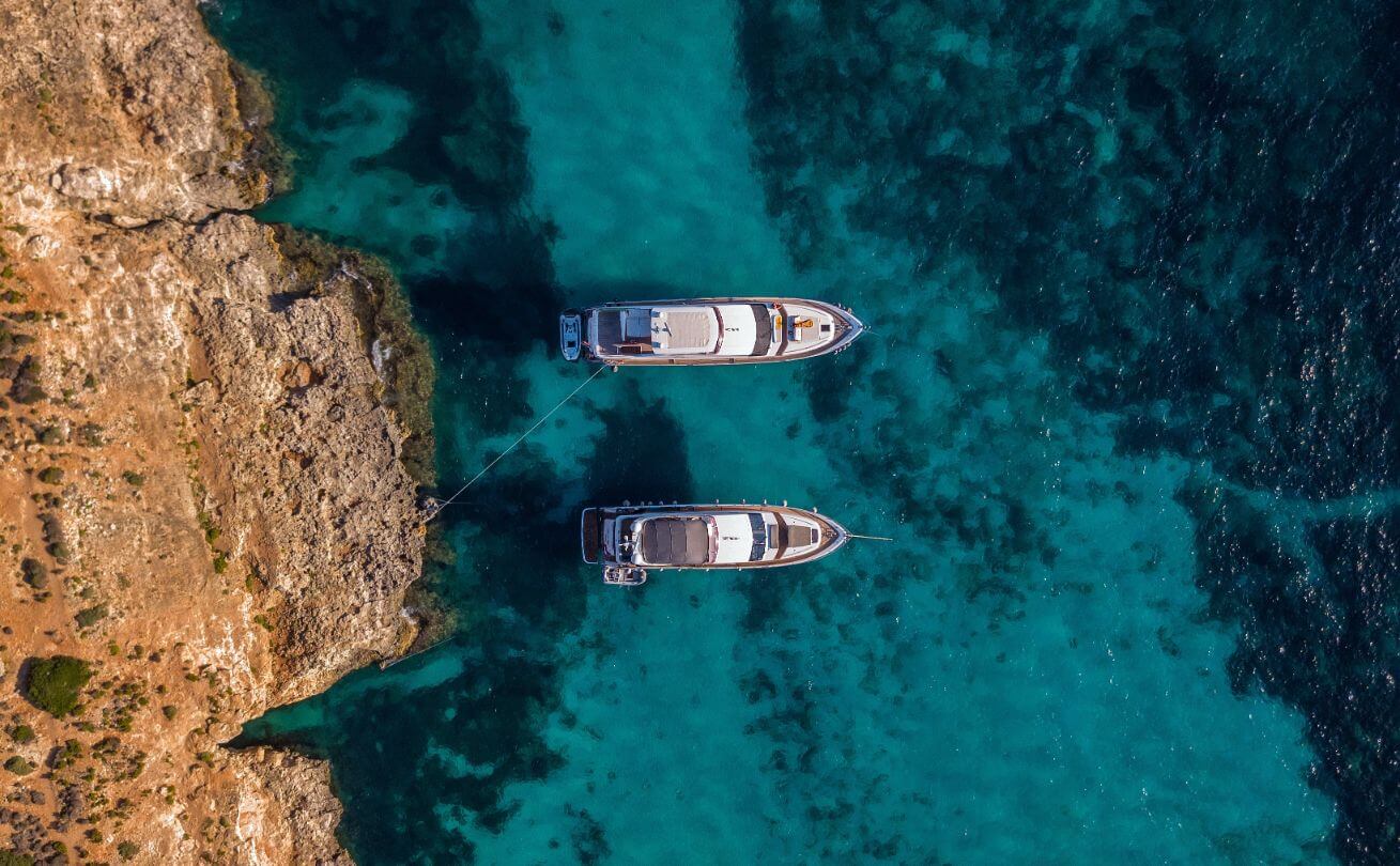 two yachts moored at a shore